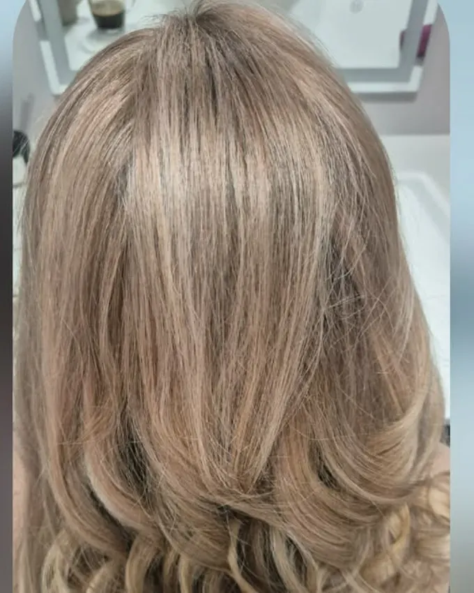 An even blond with soft curls at the ends