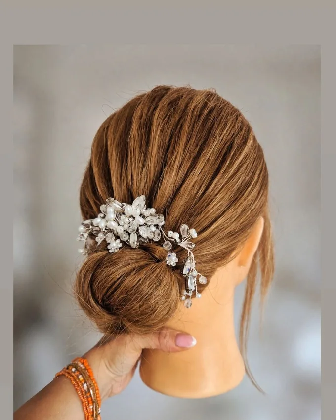 An elegant low updo with a decorative hairpin